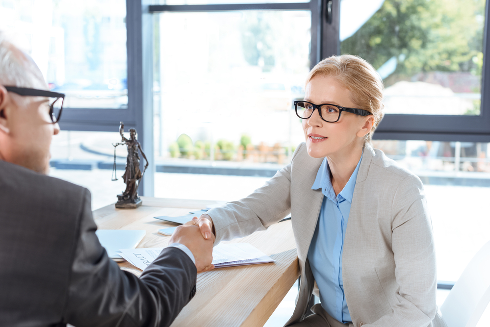 Female property manager shaking her client's hand