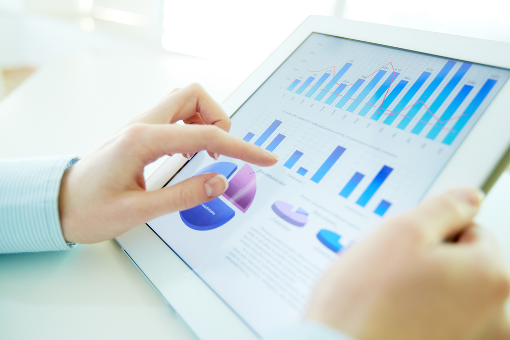 Female hands checking market rent data on a tablet